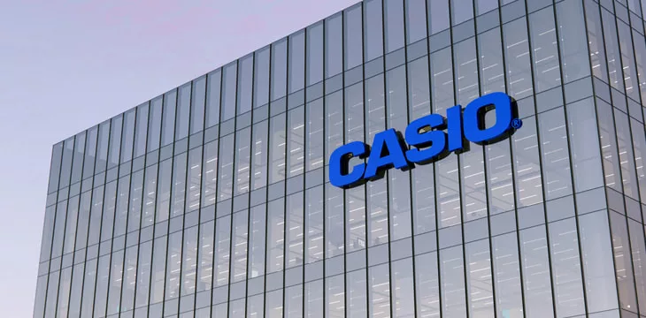 Casio Corporation Holding Signage Logo on glass building, workplace of Technological Company Office Headquarters