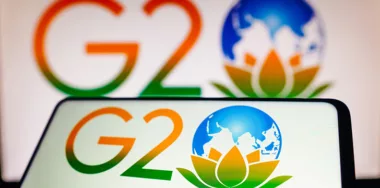 g20 logo on phone and on the wall