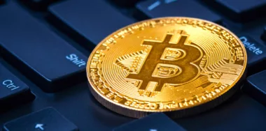 Golden bitcoin on keyboard, virtual money and cryptocurrency concept