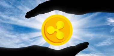 Ripple coin in the hands of man silhouette