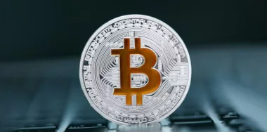 silver bitcoin with bronze logo closeup