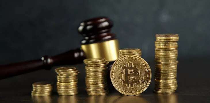 auction gavel and stacks of bitcoins