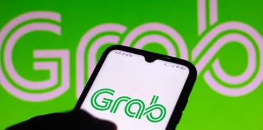 Grab logo on phone screen and background