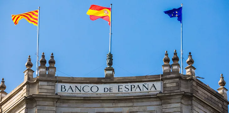 The Bank of Spain building with flags in the center of Barcelona in Plaza Catalunya