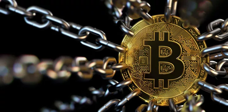 Bitcoin trapped with chains - cryptocurrencies in trouble concept. Bans, restrictions, taxes, illegal.