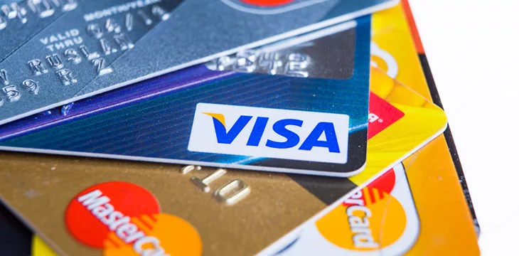 Closeup studio shot of credit cards issued by the three major brands American Express, VISA and MasterCard