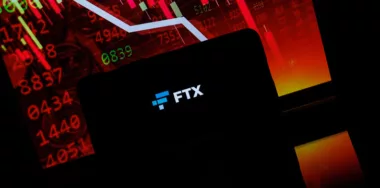 FTX company logo displayed on smartphone screen in stock background