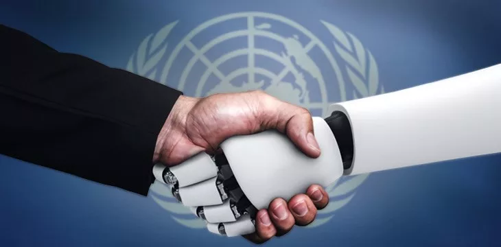 UN Flag in front of handshake of a robot and hand