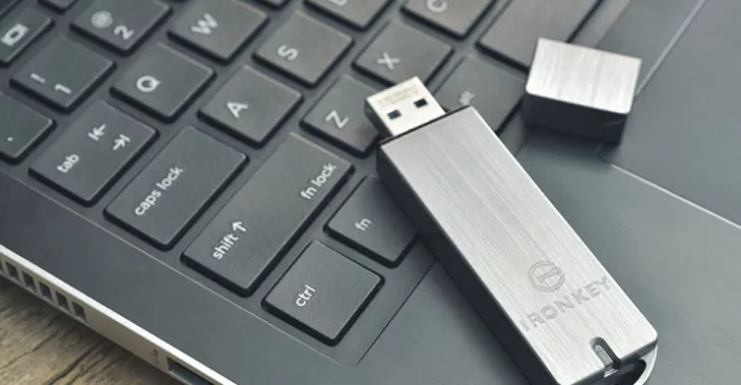 flashdrive on top of a laptop