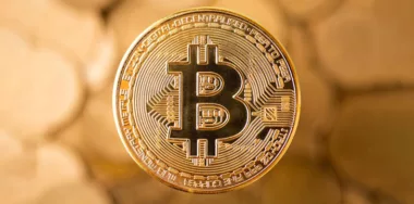 Gold bitcoin in gold background