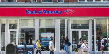 Facade of a bank branch of Bank of America on the street with people around in New York City, USA