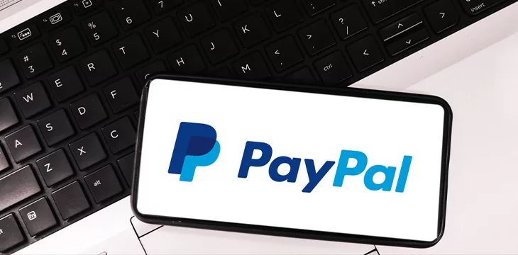 Paypal online payment gateway editorial background with mobile screen and laptop