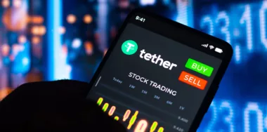 Stock trading graph of Tether (USDT) seen on a smartphone screen