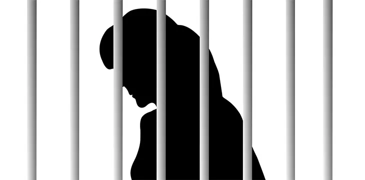 Anonymous woman behind bars