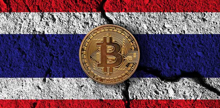 gold bitcoin on top of cracked floor with Thailand flag