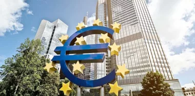 Digital Euro sign in front of buildings