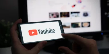 Youtube logo on phone with desktop background