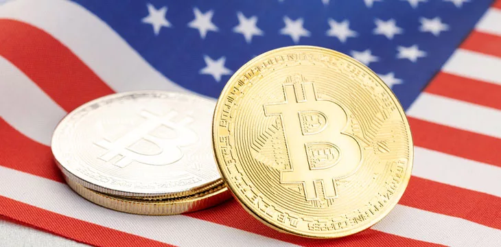 Bitcoin cryptocurrency coins on national flag of United States