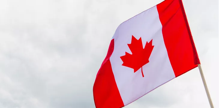 Flag of Canada with cloudy sky background