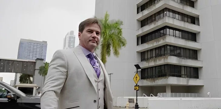 Dr. Craig Wright walking outside of a building