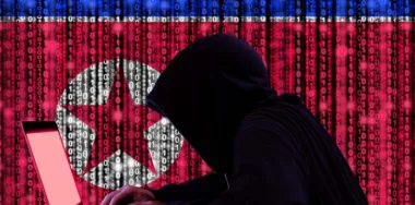 Hacker in front of a North Korean flag