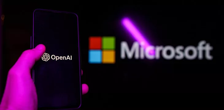 OpenAI logo on phone with Microsoft logo in the background