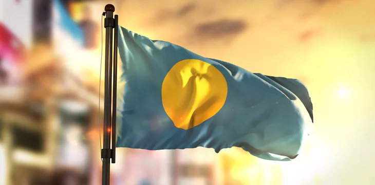 Palau Flag Against City Blurred Background