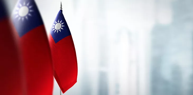 Small flags of Taiwan on a blurry background of the city