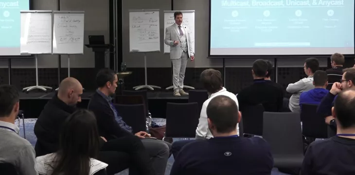 Dr. Craig Wright teaching in front of a crowd on the Bitcoin Masterclasses