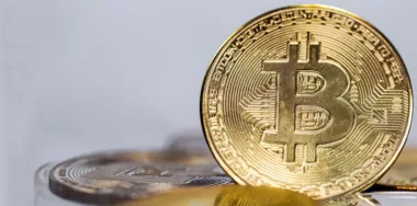 macro shot of gold bitcoin on gray background