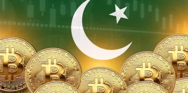 gold bitcoins in front of pakistan flag