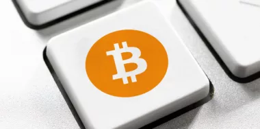 Bitcoin logo on white keyboard button