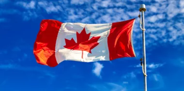 Canadian flag Waving against blue sky