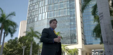 Dr. Craig Wright holding coffee outdoors