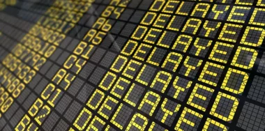 International Airport Board Close-Up with Delayed