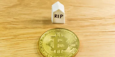End of digital currency image concept with coin and RIP block
