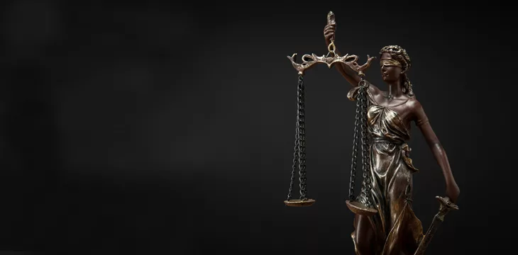 Bronze statuette with scales of justice