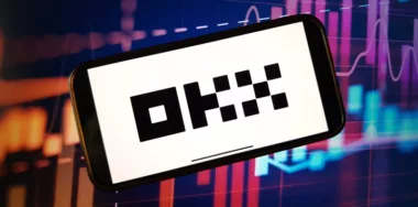 OKX cryptocurrency exchange logo displayed on smartphone
