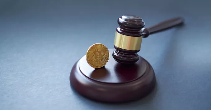 gavel and bitcoin symbol on brown table with copyspace