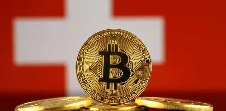 Physical version of Bitcoin and Switzerland Flag