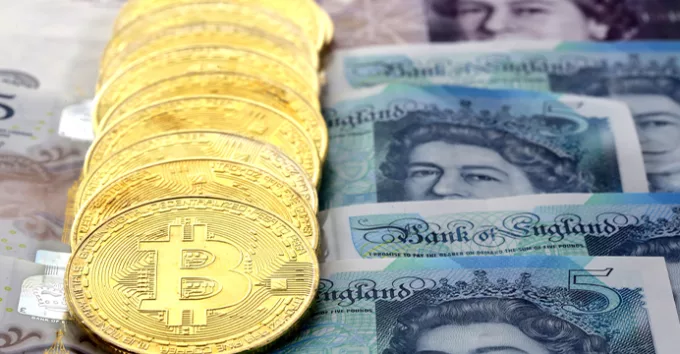 Bitcoin golden coins on United Kingdom Pound sterling banknotes