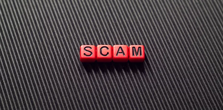 Scam - word concept on cubes