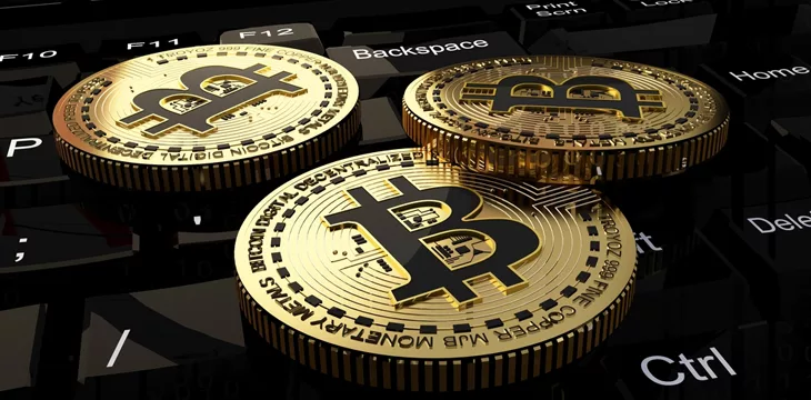Bitcoin coins on a laptop