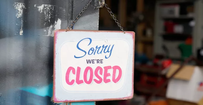 shop sign saying sorry we are closed