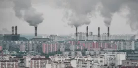Multiple factory pipes producing coal smoke