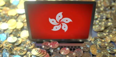 Flag on the laptop screen and many bitcoins