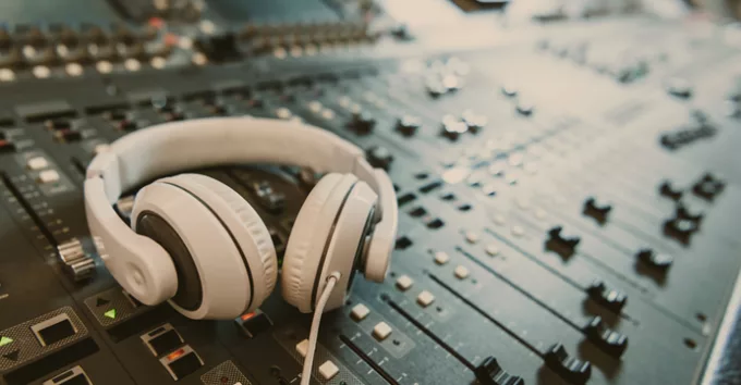 Close-up shot of headphones on graphic equalizer