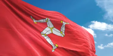 Isle of Mann flag waving sky background