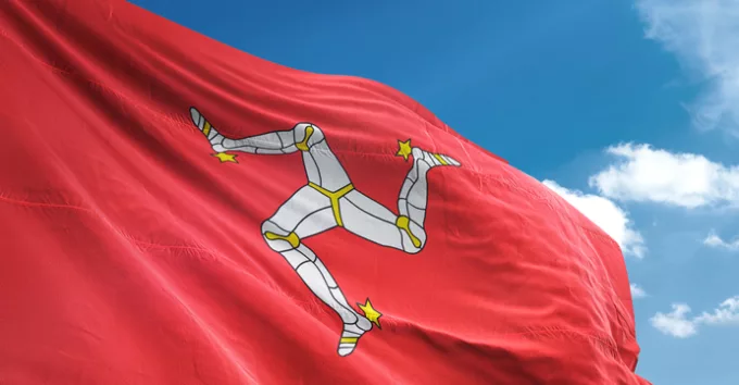 Isle of Mann flag waving sky background