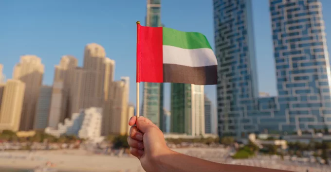 Close up of a female hand holding tiny flag of UA